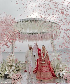 Rose Petal Shower Under a Circular Floral Structure