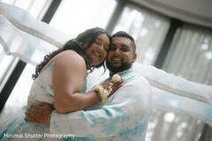 Couple Embraces in Coordinated Blue and White Attire