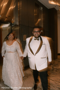 Joyful Couple's Grand Entrance in Elegant White Attire