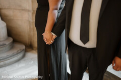 Two People in Black Attire Holding Hands
