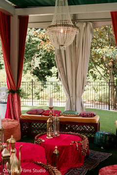 Vibrant Red and Gold Lounge Decor with Crystal Chandelier