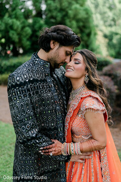 Groom Kisses Bride's Forehead in Outdoor Portrait