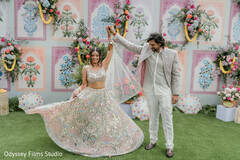 Couple Twirls in Shimmering Lehenga and Light-Colored Suit