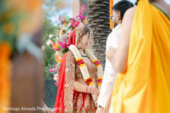 Bride in Red Lehenga with Floral Garland