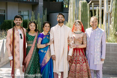 Family Portrait with Bride in Red Lehenga and Groom in Cream Sherwani