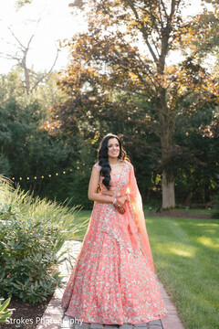 Peach Lehenga with Intricate Embroidery for an Outdoor Portrait