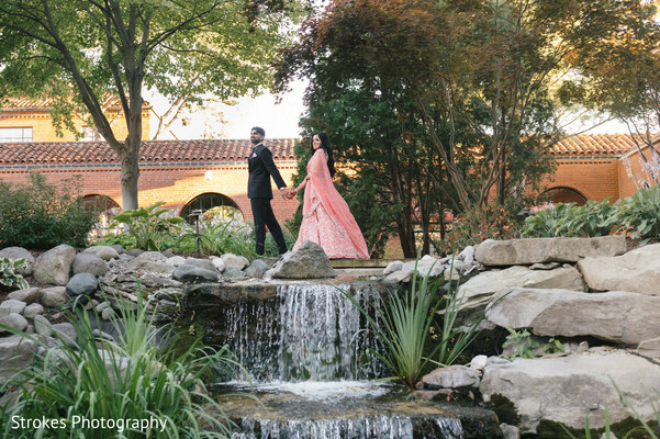 couple portrait,peach lehenga,dark blue suit,water feature,outdoor