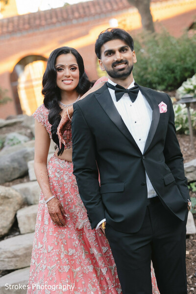 couple portrait,pink lehenga,black tuxedo,bridal fashion,groom fashion,wedding attire
