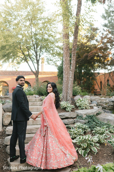 couple portrait,peach lehenga,groom suit,outdoor wedding,garden setting