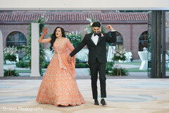 Joyful Couple Dances in Peach Lehenga and Black Tuxedo at Reception