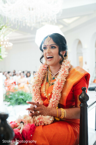bride,orange saree,flower necklace,bridal jewelry,happy bride,traditional attire,bridal fashion