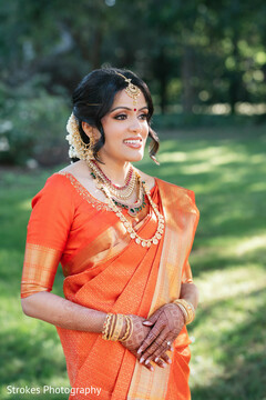 Radiant Bride in Orange Saree and Gold Temple Jewelry