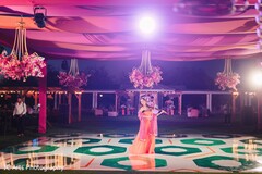 Performer on Illuminated Dance Floor with Abstract Pattern