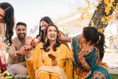 Woman in Yellow Outfit Laughing with Friends