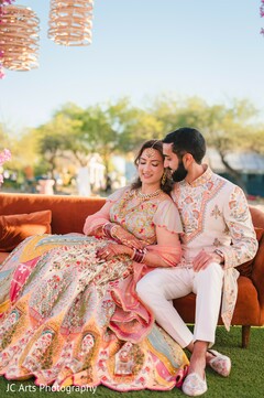 Couple on Rust Sofa with Floral Lehenga