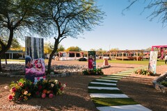 Outdoor Wedding Aisle with Green and White Stripes and Photo Displays