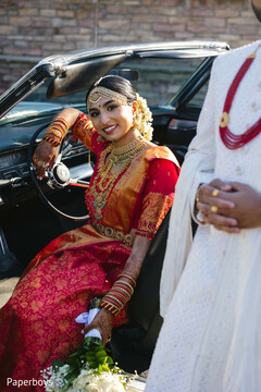 Radiant Bride in Red Sari with Gold Jewelry in Classic Car