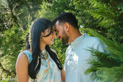 Foreheads Touching Amidst Lush Greenery
