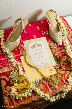 Gold and Ivory Wedding Invitation with Floral Garlands and Bridal Jewelry
