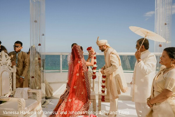 wedding,ceremony,floral garlands,red lehenga,outdoor wedding,balcony ceremony