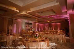 Elegant Reception Hall with Warm Lighting and Floral Centerpieces
