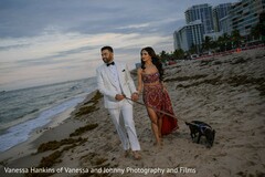 Couple Walks on Beach with Dog in White Suit and Burgundy Lehenga