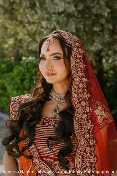 Stunning Bridal Portrait with Red Lehenga and Intricate Jewelry