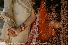 Intimate Hand-Holding: Bride's Red Lehenga & Groom's Embroidered Sherwani
