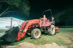 Bride Poses on a Red Tractor at Night