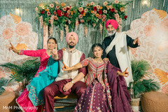 Joyful Family Portrait with Maroon Lehenga and Cream Sherwani