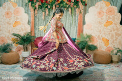 Bride Twirling in Maroon Lehenga with Floral Embroidery and Decorative Panels