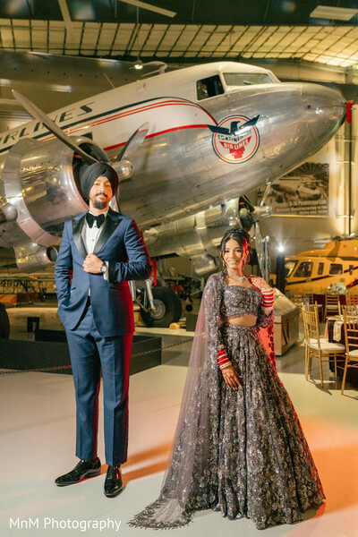 Couple Poses in Front of a Vintage Airplane