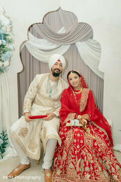 Bride in Red Lehenga and Groom in Ivory Sherwani with Turban