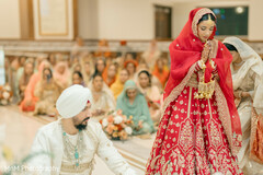 Bride in Red Lehenga with Groom in White Kurta During Ceremony