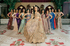 Bride in Golden Lehenga with Bridal Party on Patterned Floor