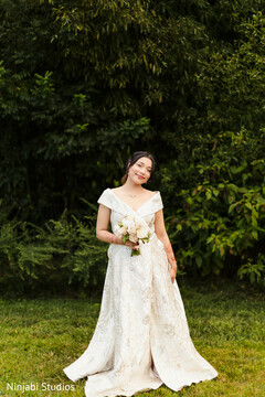 Elegant Bride in Off-Shoulder Gown with Blush Floral Bouquet