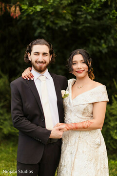 Couple Portrait in Off-White and Black Attire with Mehndi Detail