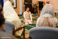 Man Kneeling on a Patterned Carpet