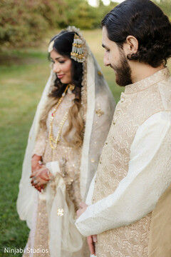 Couple in Ivory and Gold Wedding Attire Outdoors