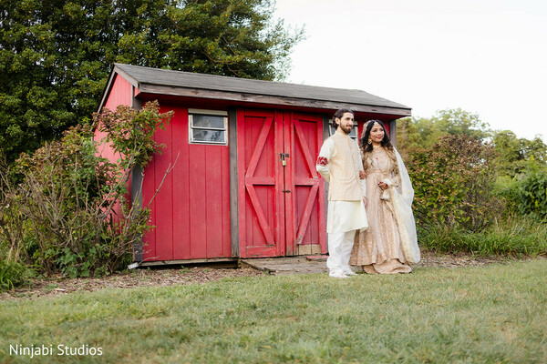 couple portrait,cream lehenga,cream kurta,white pajama,red barn,rustic wedding,outdoor photography,pre-wedding fashion,wedding photos