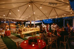 Outdoor Tent Celebration with String Lights and Floral Accents