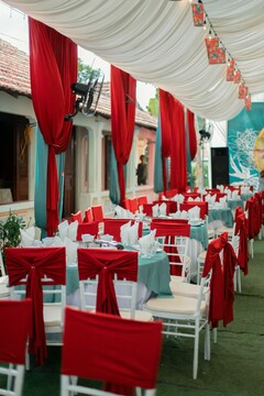 Draped Red and Teal Fabric Over Event Tables