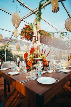 Red Floral Centerpiece Under Woven Pendant Lights