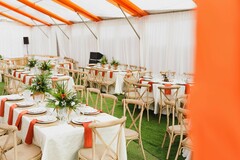 Vibrant Outdoor Reception Tent with Orange and Green Accents