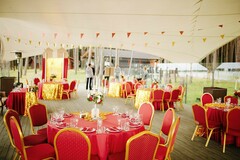 Red and Gold Seating Under a White Tent with Red Pennants