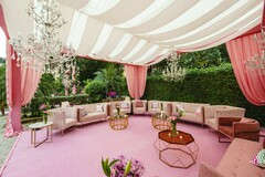 Outdoor Lounge with Striped Canopy and Pink Decor