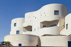 Modern White Architectural Venue with Curved Walls and Blue Accents