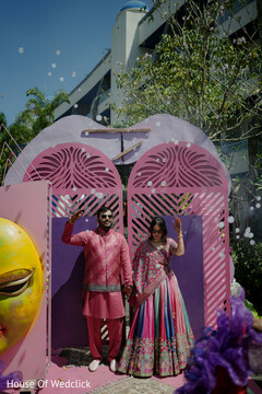 Couple Poses by Pink and Purple Archways with Bubbles