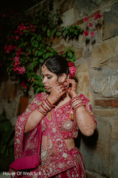 Bride Adorns Herself in Pink Lehenga and Ornate Jewelry