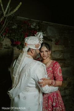 Intimate Couple's Embrace: Pink Lehenga & White Sherwani